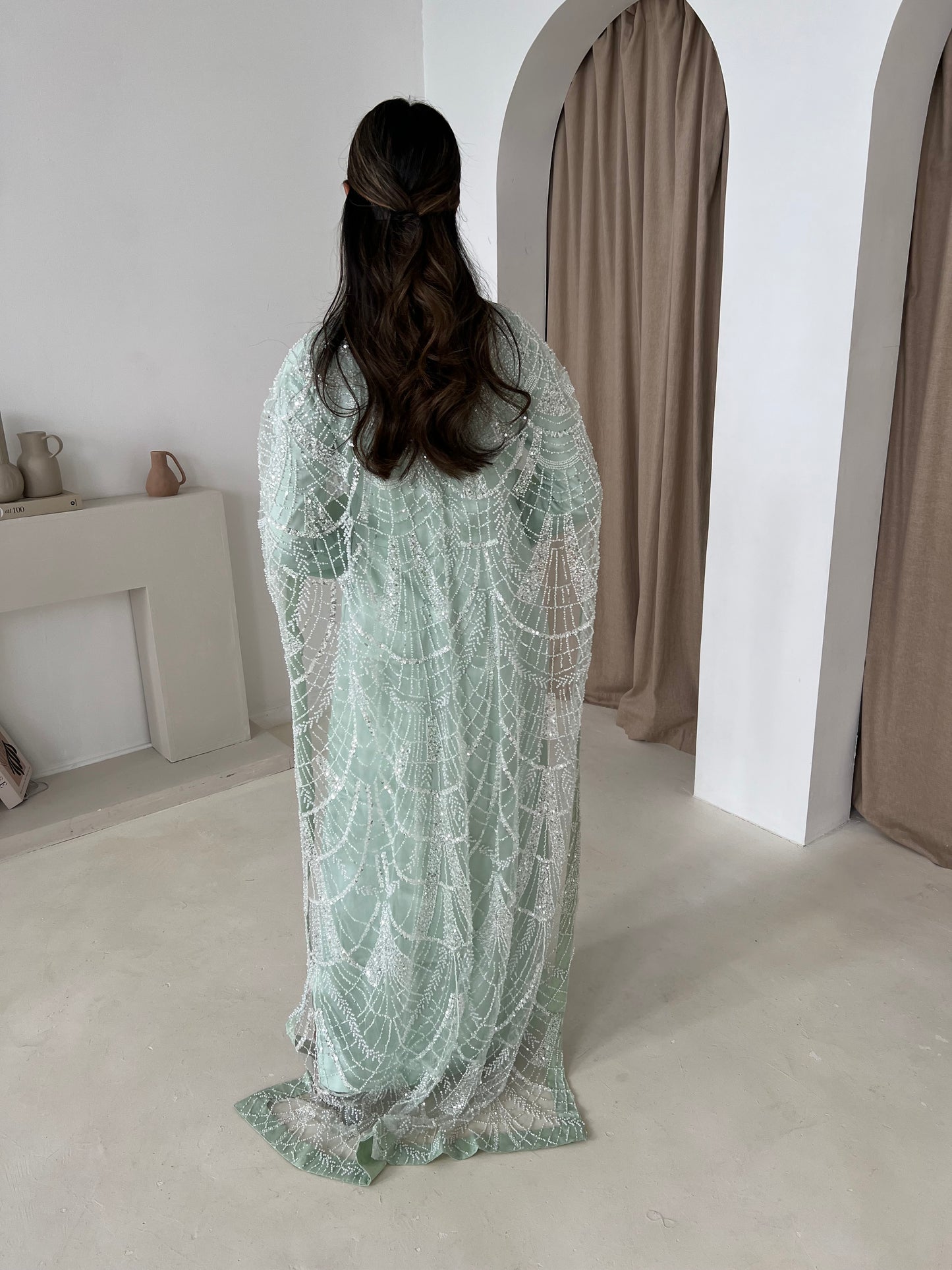 Back view of Dina Mint trail cape showing 60-inch length